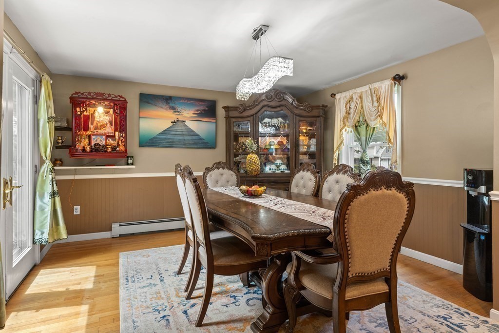 73 Baldwin Road Billerica, MA 01821 - Photo 13 of 40 a dining room with furniture a large window and a chandelier