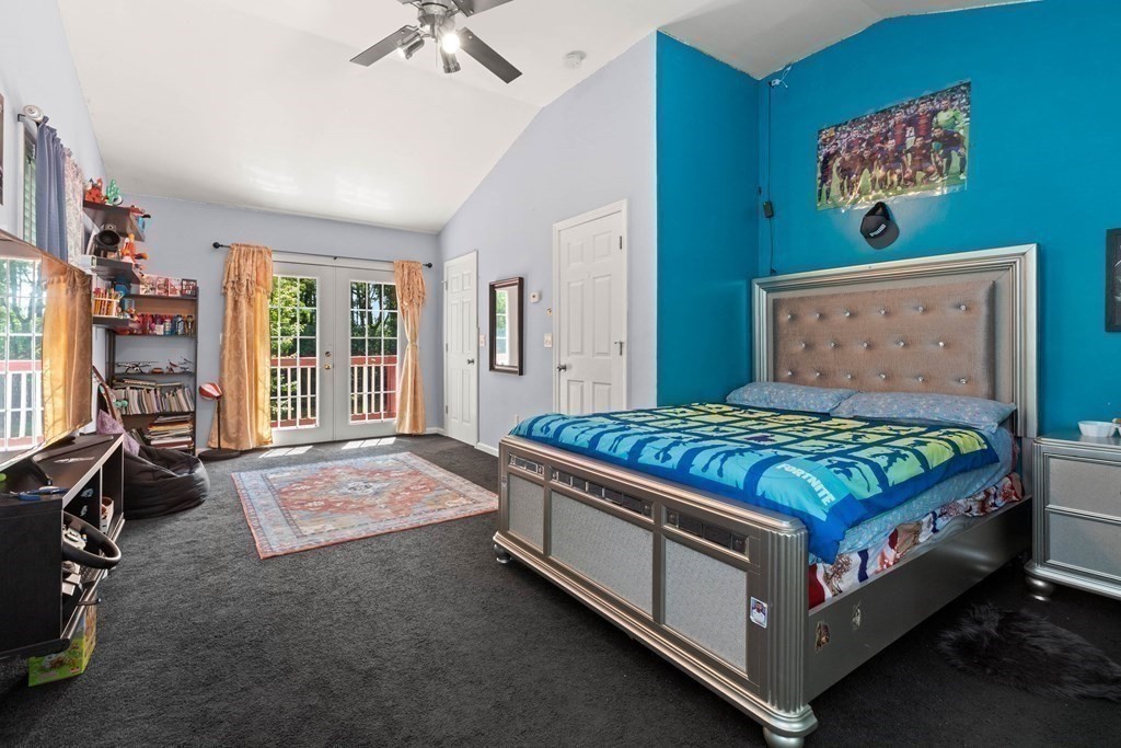 73 Baldwin Road Billerica, MA 01821 - Photo 17 of 40 a bedroom with a bed and a chandelier