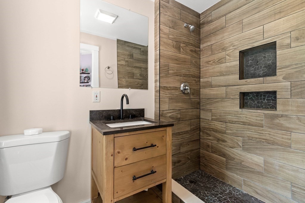 73 Baldwin Road Billerica, MA 01821 - Photo 19 of 40 a bathroom with a sink a toilet and shower