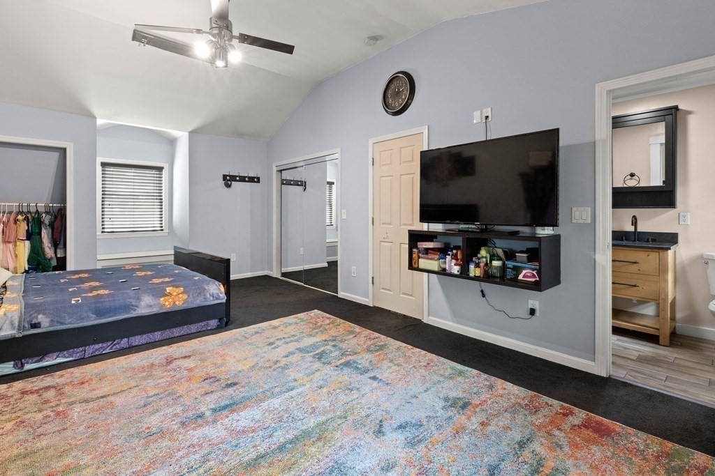 73 Baldwin Road Billerica, MA 01821 - Photo 20 of 40 a bedroom with furniture and a flat screen tv