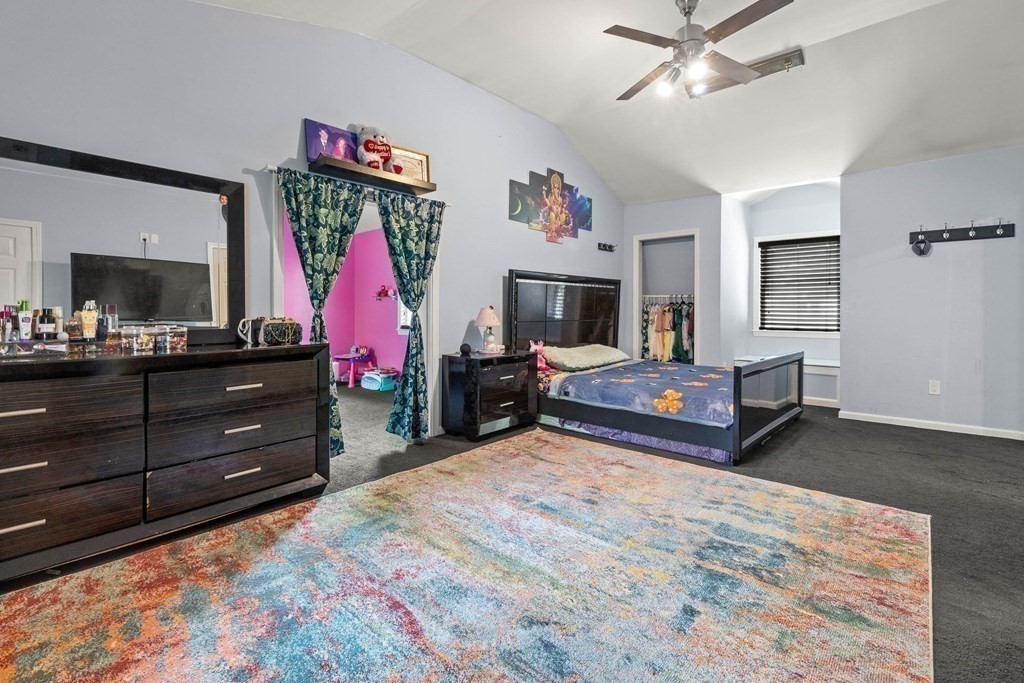 73 Baldwin Road Billerica, MA 01821 - Photo 22 of 40 a bed room with a bed and a television