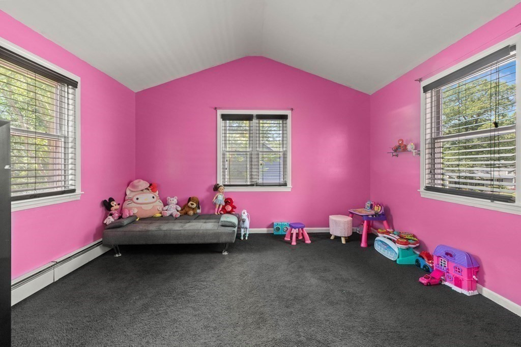 73 Baldwin Road Billerica, MA 01821 - Photo 23 of 40 a bedroom with pink walls and chandelier