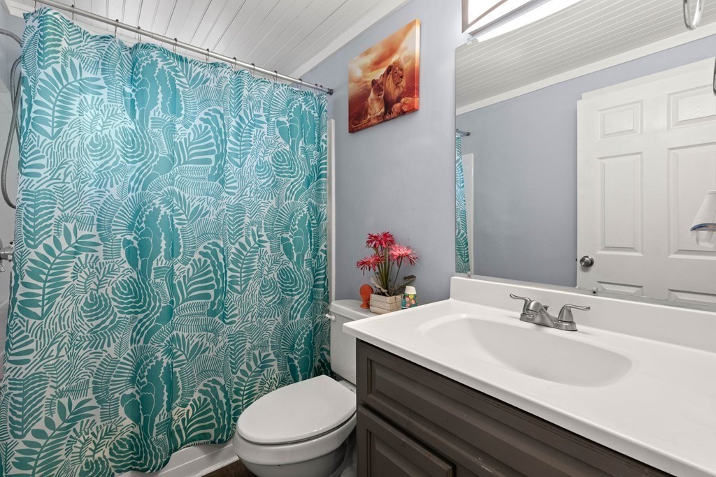73 Baldwin Road Billerica, MA 01821 - Photo 27 of 40 a bathroom with a sink a toilet and shower curtain