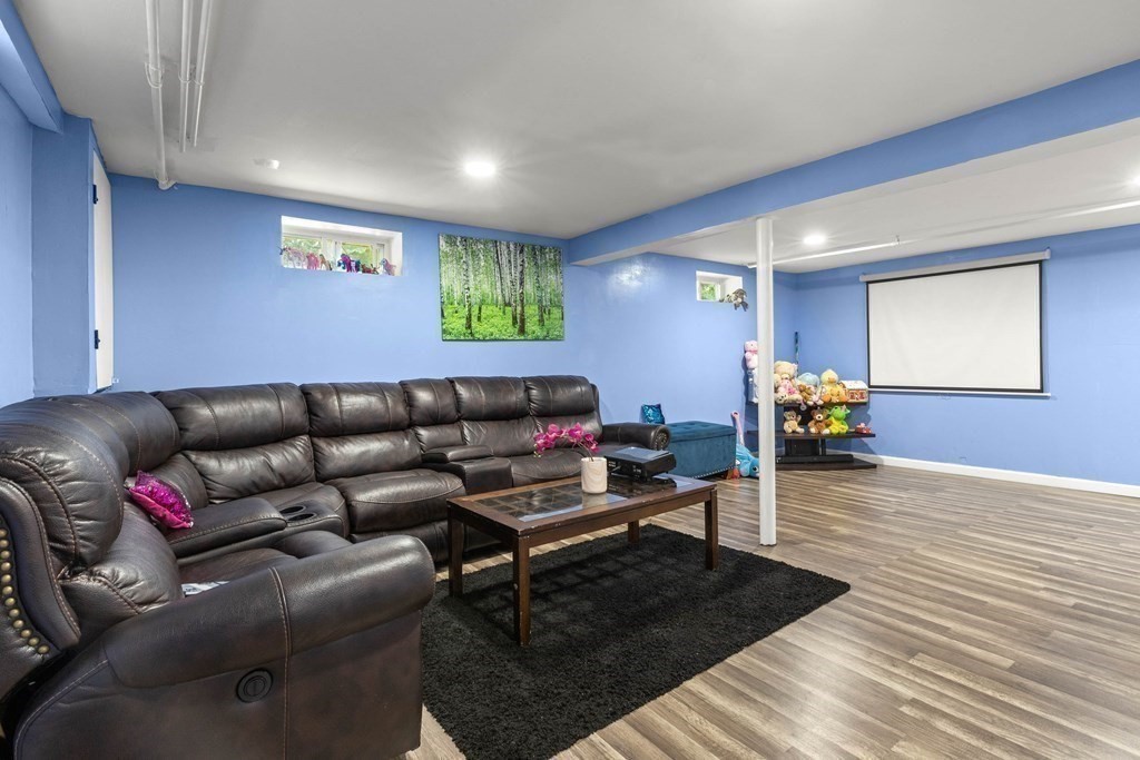 73 Baldwin Road Billerica, MA 01821 - Photo 30 of 40 a living room with furniture and a wooden floor
