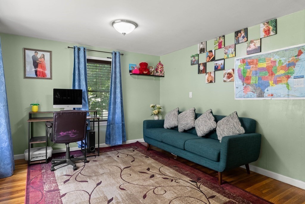 73 Baldwin Road Billerica, MA 01821 - Photo 7 of 40 a living room with furniture and a flat screen tv