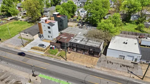 an aerial view of a house with garden space and sitting area