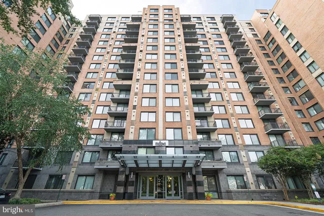 a living room with furniture a fireplace and a dining table with kitchen view