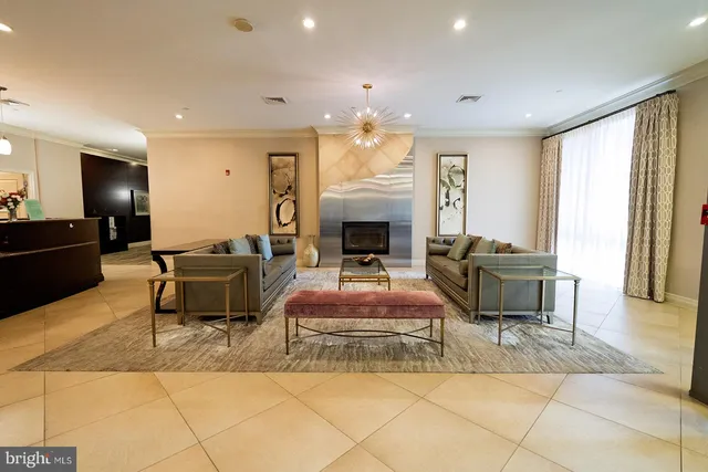 a living room with furniture and large windows