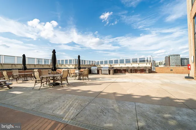 a living room with lots of furniture and a large window