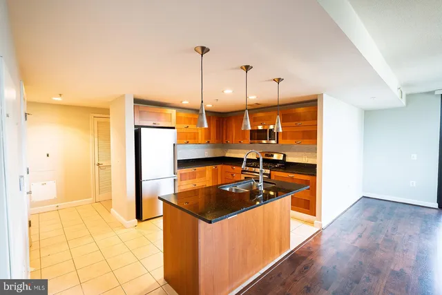 a kitchen that has a sink a stove and a refrigerator