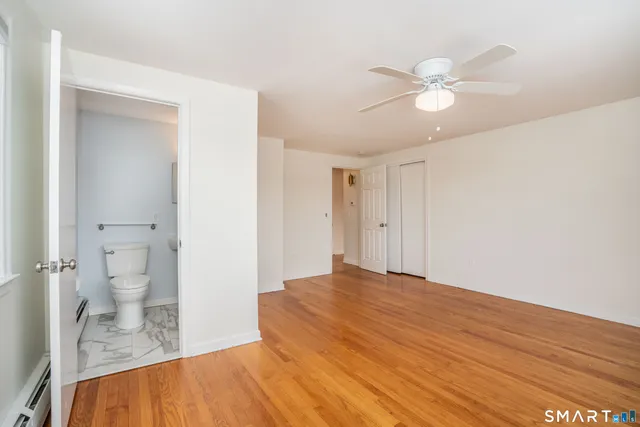a bedroom with a bed and a view of bathroom