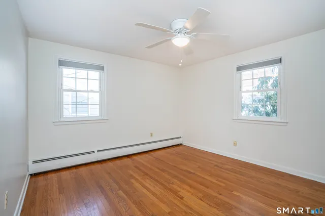 wooden floor in an empty room with a window