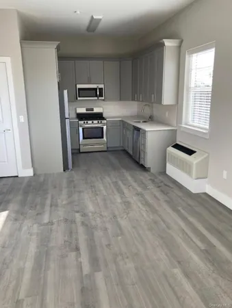 a kitchen with stainless steel appliances a refrigerator sink and microwave