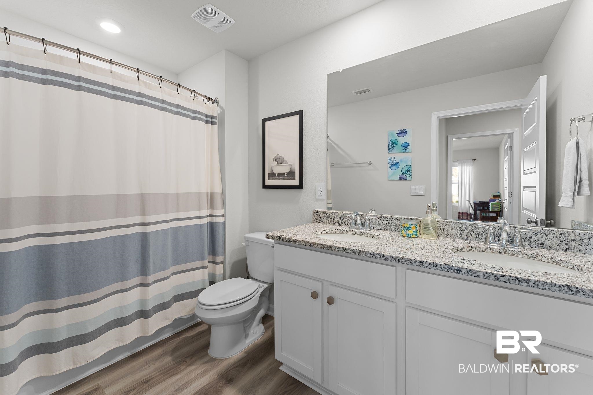 24337 Ringneck Loop Elberta, AL 36530 - Photo 22 of 34 Bathroom with a shower with shower curtain, double vanity, and dark wood-style floors