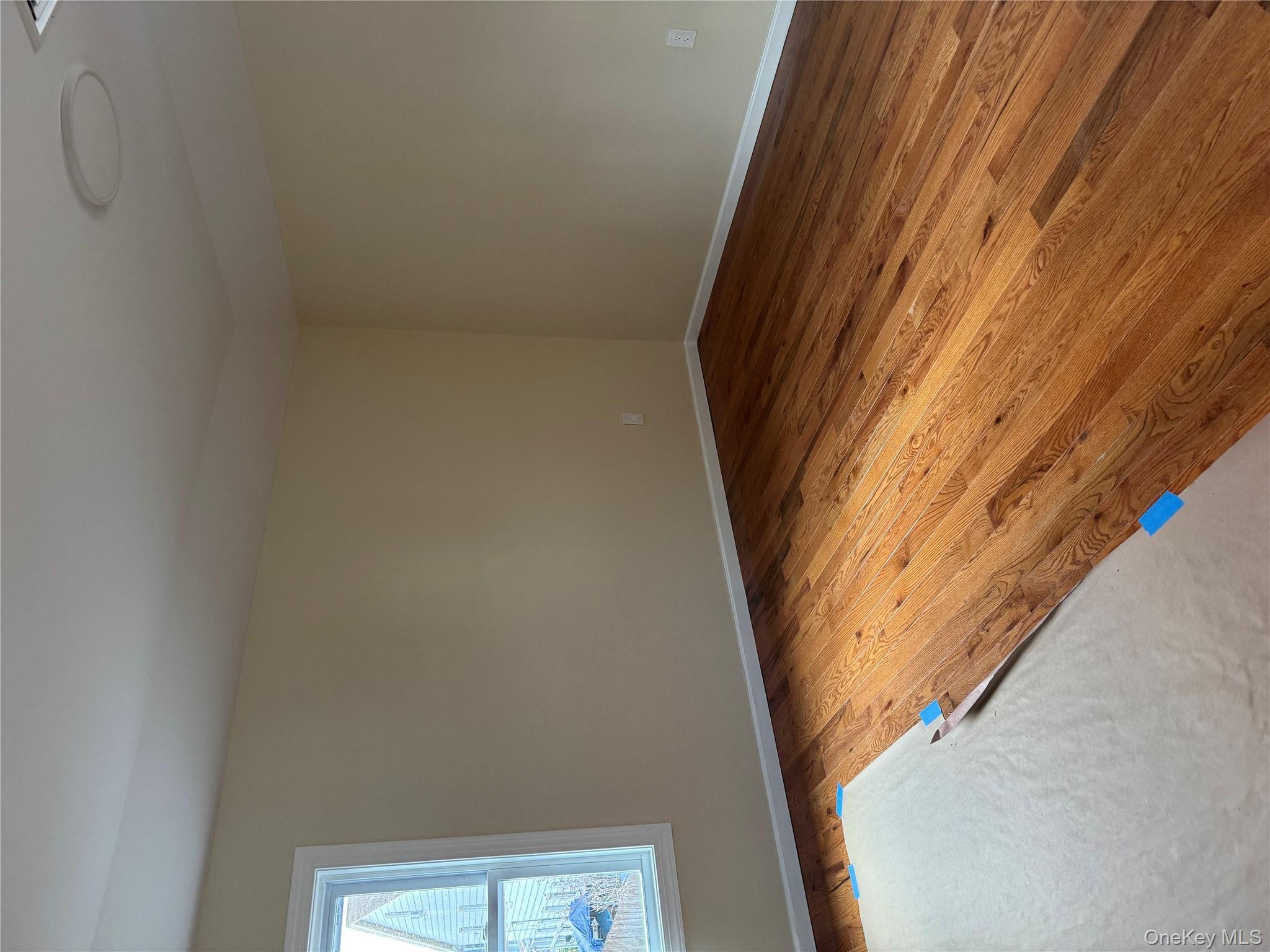 118-32 200th Street, Unit 2 Queens, NY 11412 - Photo 3 of 5 Empty room with light wood-style flooring and baseboards