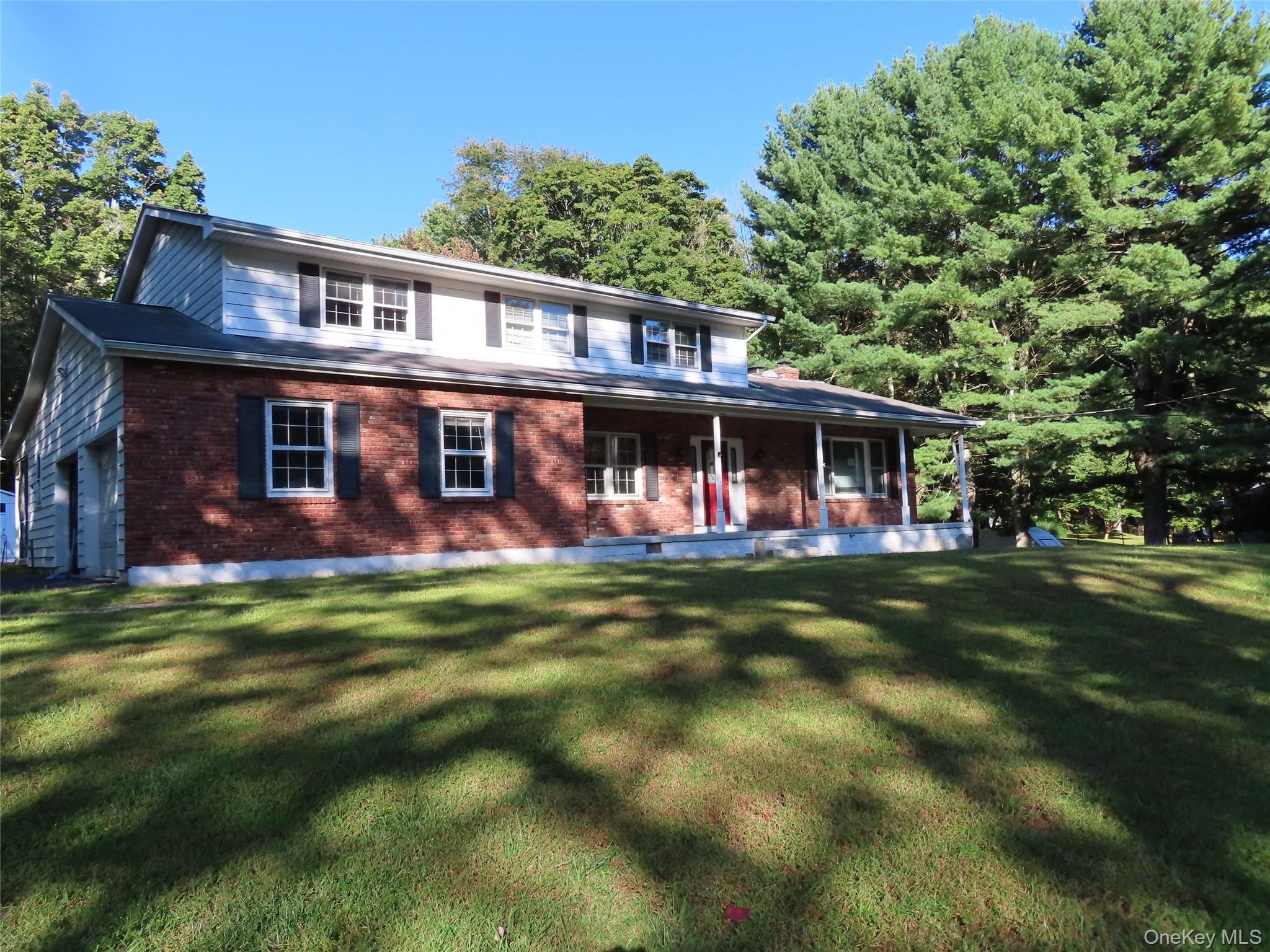 26 Darren Road LaGrangeville, NY 12540 - Photo 2 of 28 View of front of home featuring a porch, brick siding, a front yard,