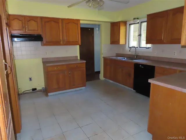 a kitchen with granite countertop a refrigerator and a sink
