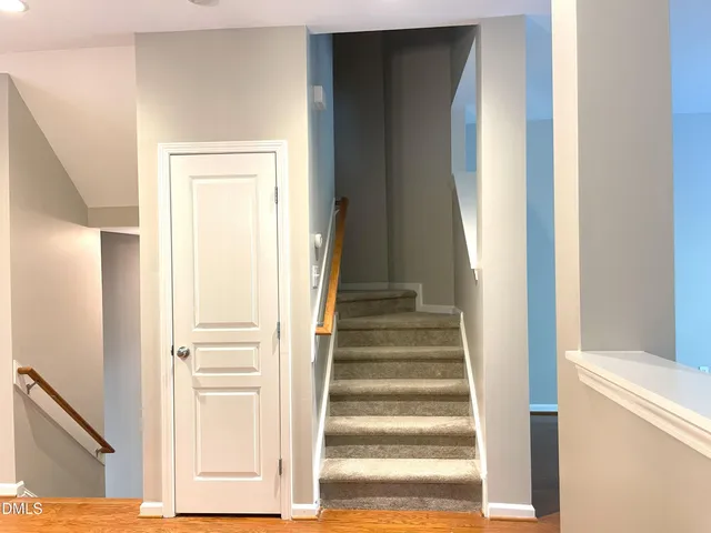 a view of staircase with white walls and a window