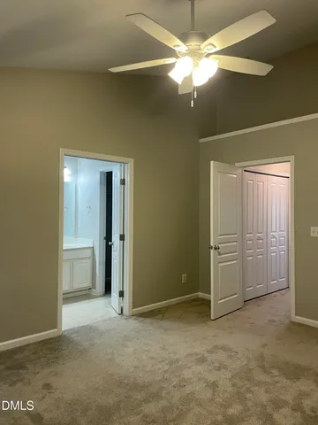 a view of an empty room with a ceiling fan