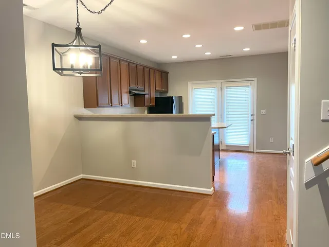 a view of a kitchen with a sink and wooden floor