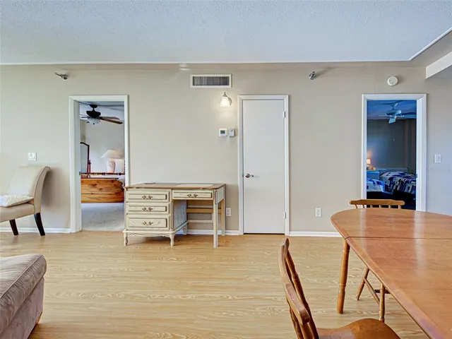 a dining room with furniture and wooden floor