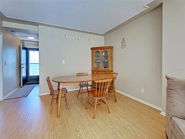 a dining room with furniture and wooden floor