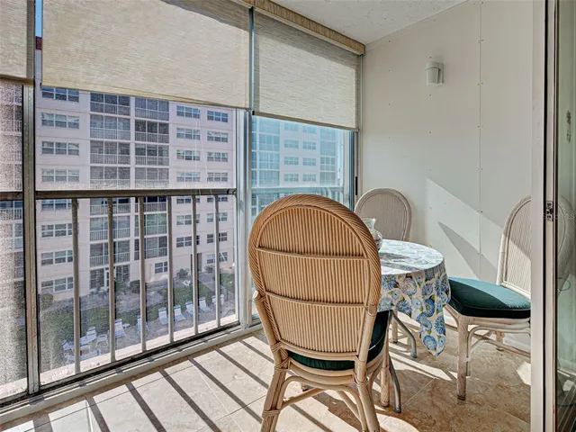 a view of a balcony with table and chairs