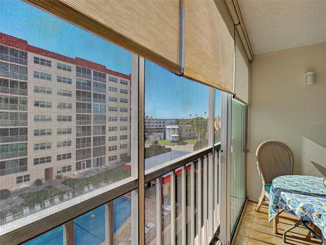 a view of balcony with wooden floor and outdoor seating