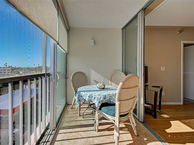 a dinning table and chairs in a balcony