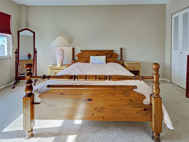 a bed sitting in a room next to a window