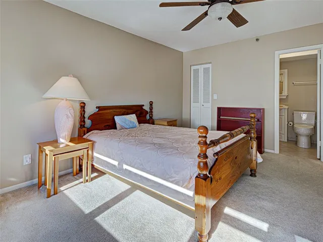 a bed room with a bed and a chair