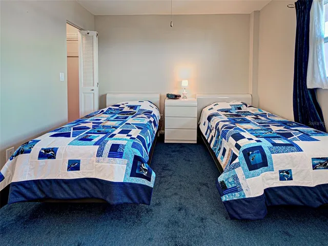 a bedroom with two beds and a tv