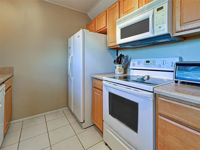a kitchen with stainless steel appliances granite countertop a stove a microwave and a sink