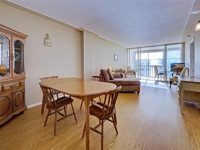 a dining room with furniture and wooden floor