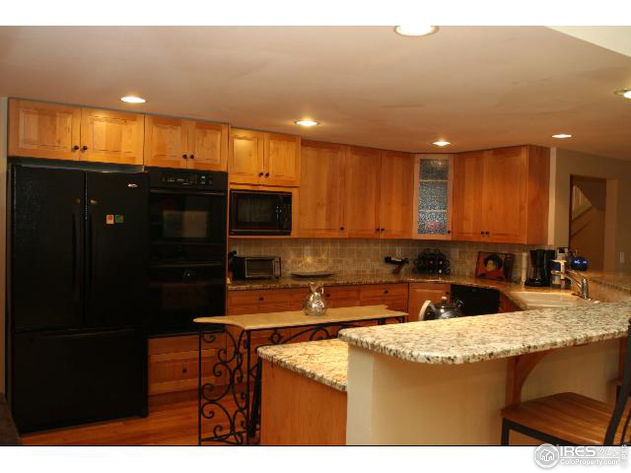 7121 Four Rivers Road Boulder, CO 80301 - Photo 4 of 17 a kitchen with stainless steel appliances granite countertop a sink a stove and a refrigerator