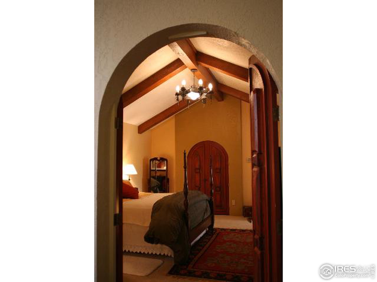 7121 Four Rivers Road Boulder, CO 80301 - Photo 5 of 17 a bedroom with a bed and a mirror