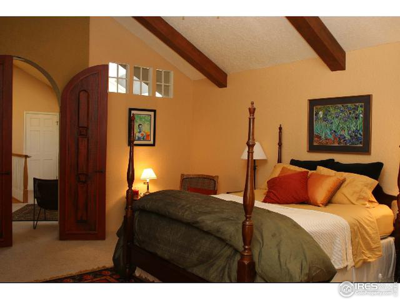 7121 Four Rivers Road Boulder, CO 80301 - Photo 6 of 17 a bedroom with a bed and a chandelier