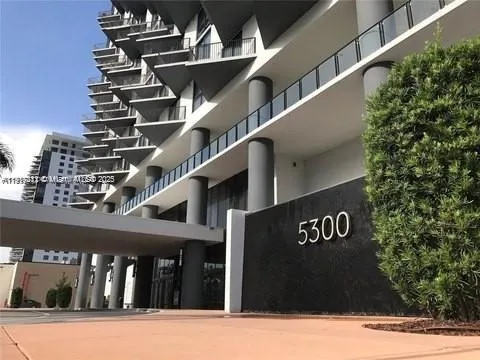 a black car parked in front of a building