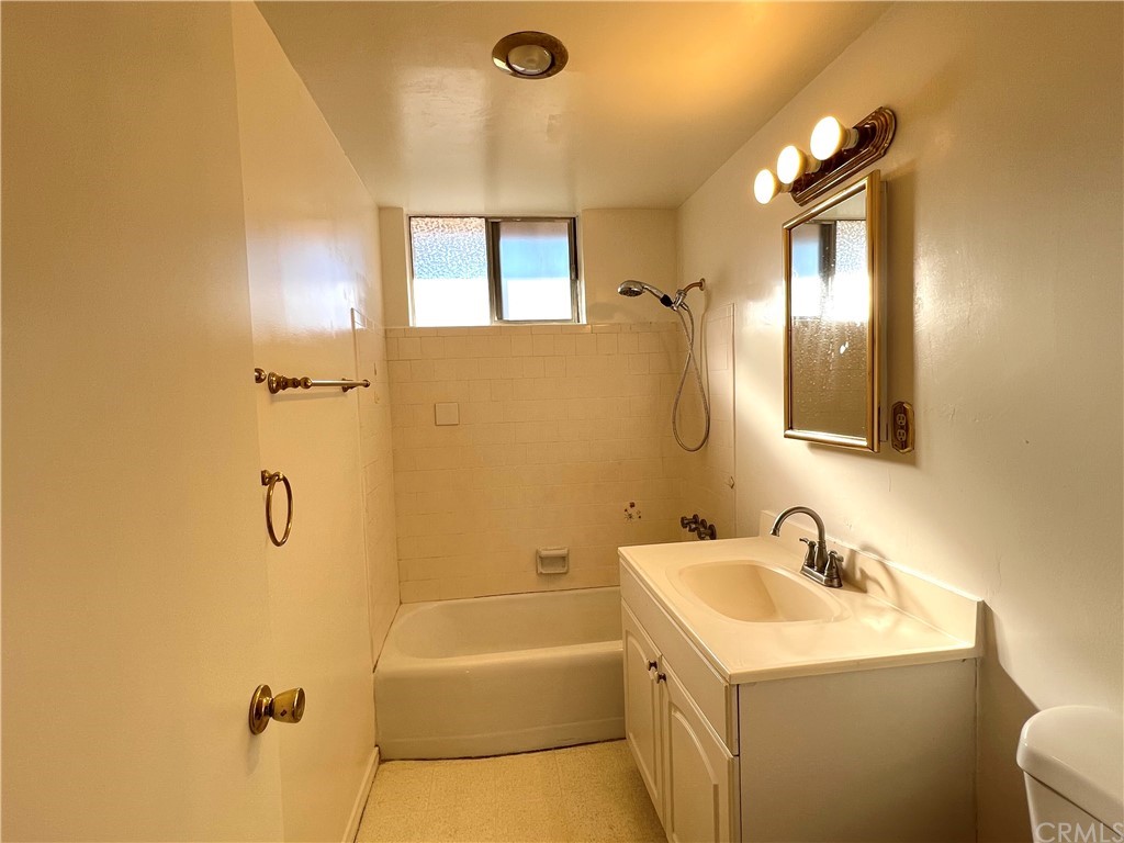 8716 Duarte Road San Gabriel, CA 91775 - Photo 12 of 21 a bathroom with a tub sink and mirror