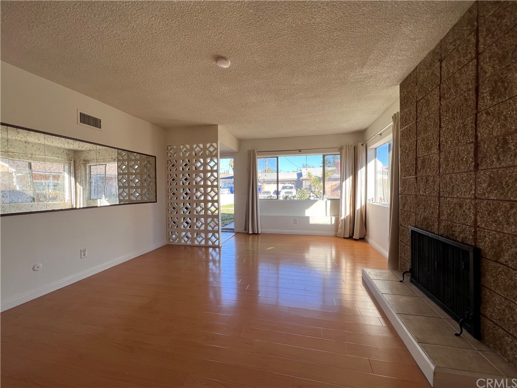 8716 Duarte Road San Gabriel, CA 91775 - Photo 5 of 21 a view of an empty room with a window and wooden floor