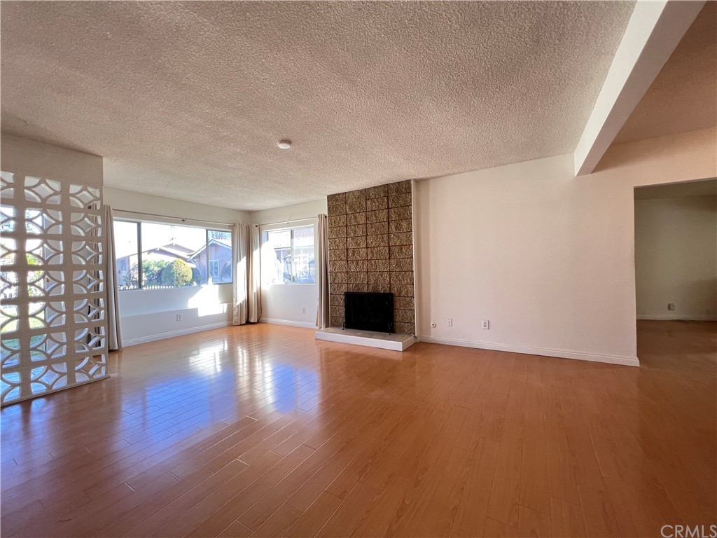 8716 Duarte Road San Gabriel, CA 91775 - Photo 6 of 21 a view of an empty room with a fireplace and a window