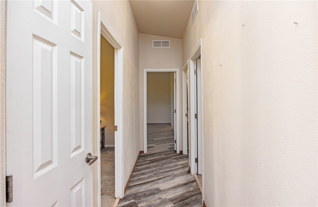 4206 Cordes Road Golden Valley, AZ 86413 - Photo 13 of 60 Hallway featuring textured walls, white trim, and doors