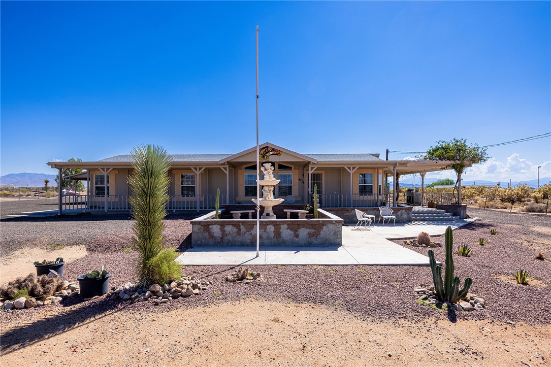 4206 Cordes Road Golden Valley, AZ 86413 - Photo 2 of 60 The property features a desert-style landscape with gravel ground cover and various cacti