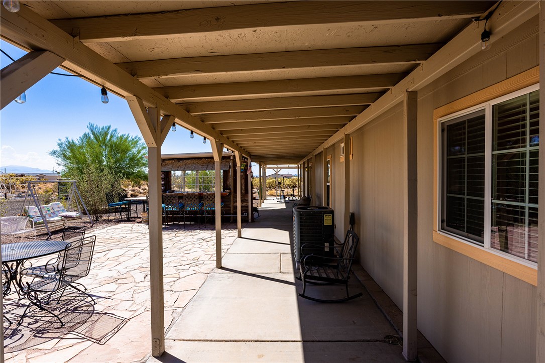 4206 Cordes Road Golden Valley, AZ 86413 - Photo 28 of 60 The property features an extensive covered patio with exposed beam ceiling, providing ample shaded outdoor living space