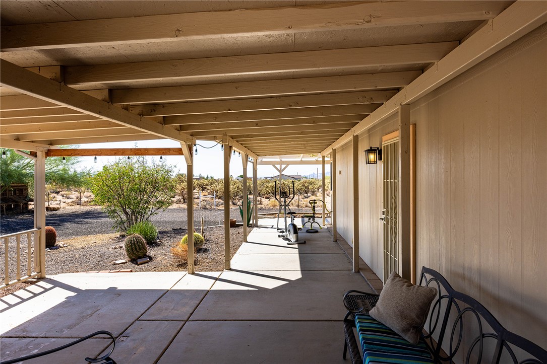 4206 Cordes Road Golden Valley, AZ 86413 - Photo 29 of 60 The property features an extensive covered patio with exposed beams, providing shade and outdoor living space