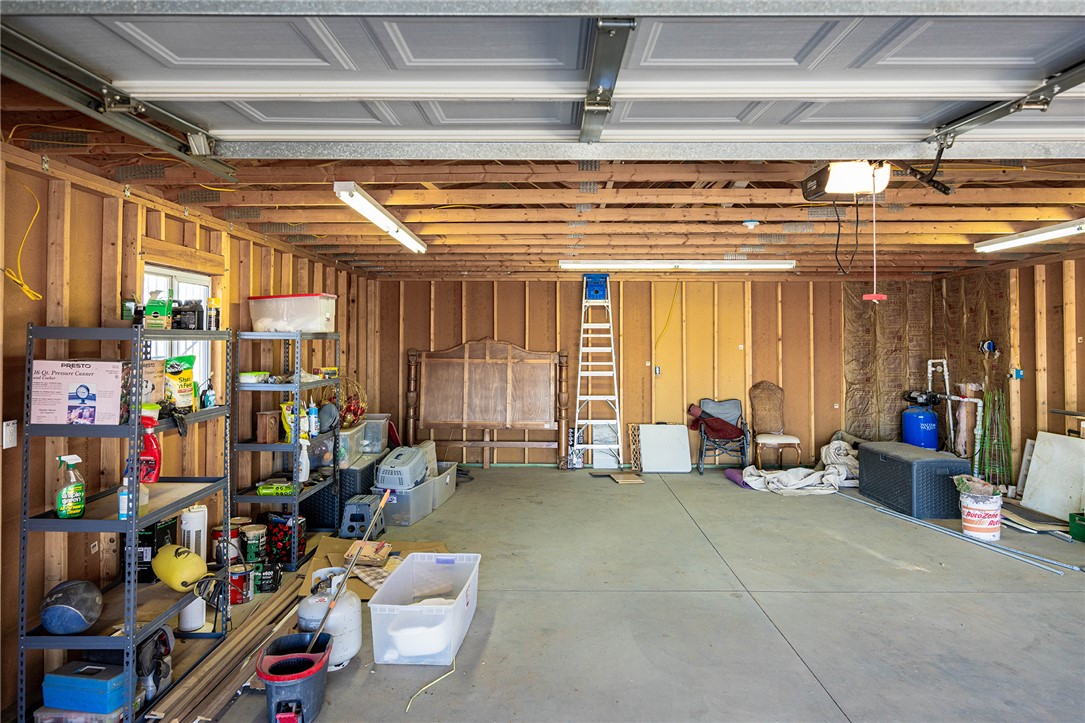 4206 Cordes Road Golden Valley, AZ 86413 - Photo 38 of 60 Spacious garage with a concrete floor, exposed wooden studs, and overhead fluorescent lighting