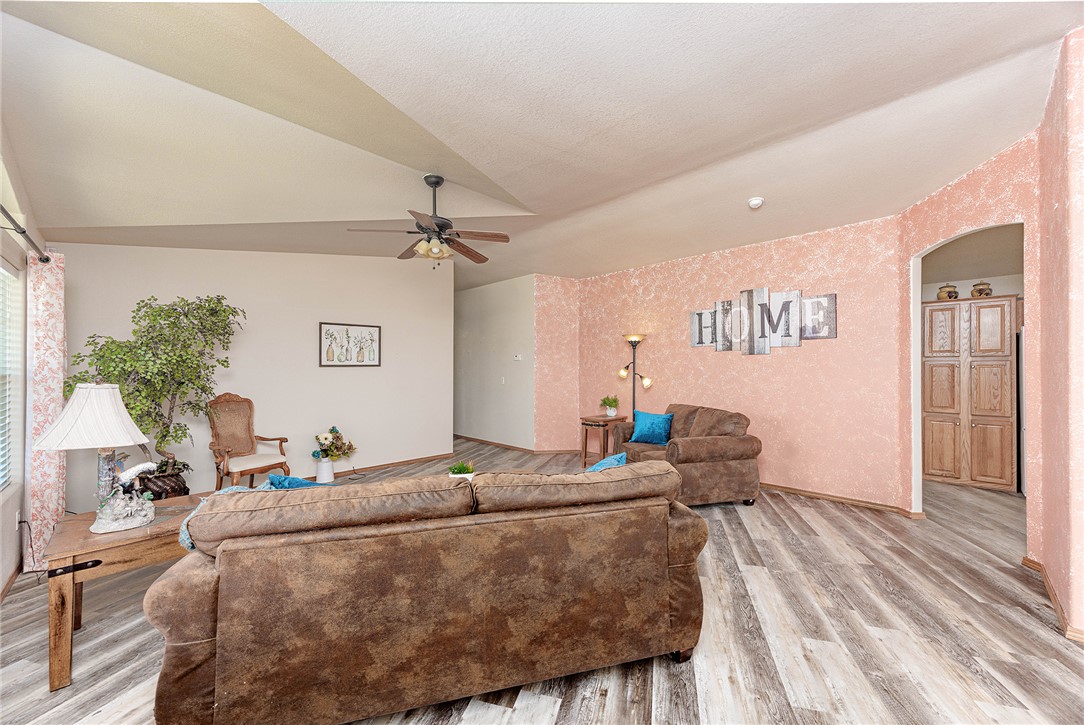 4206 Cordes Road Golden Valley, AZ 86413 - Photo 4 of 60 Spacious living area featuring vaulted ceilings, a ceiling fan, and light-toned flooring