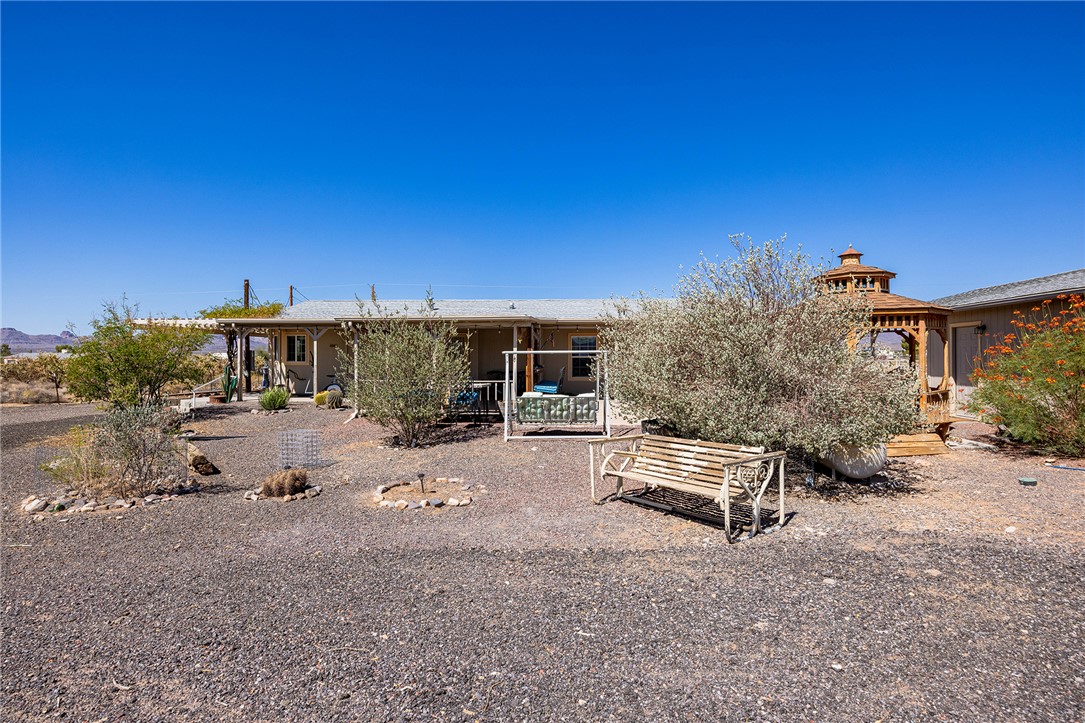 4206 Cordes Road Golden Valley, AZ 86413 - Photo 49 of 60 The property features a covered patio, a wooden gazebo, and mature shrubs