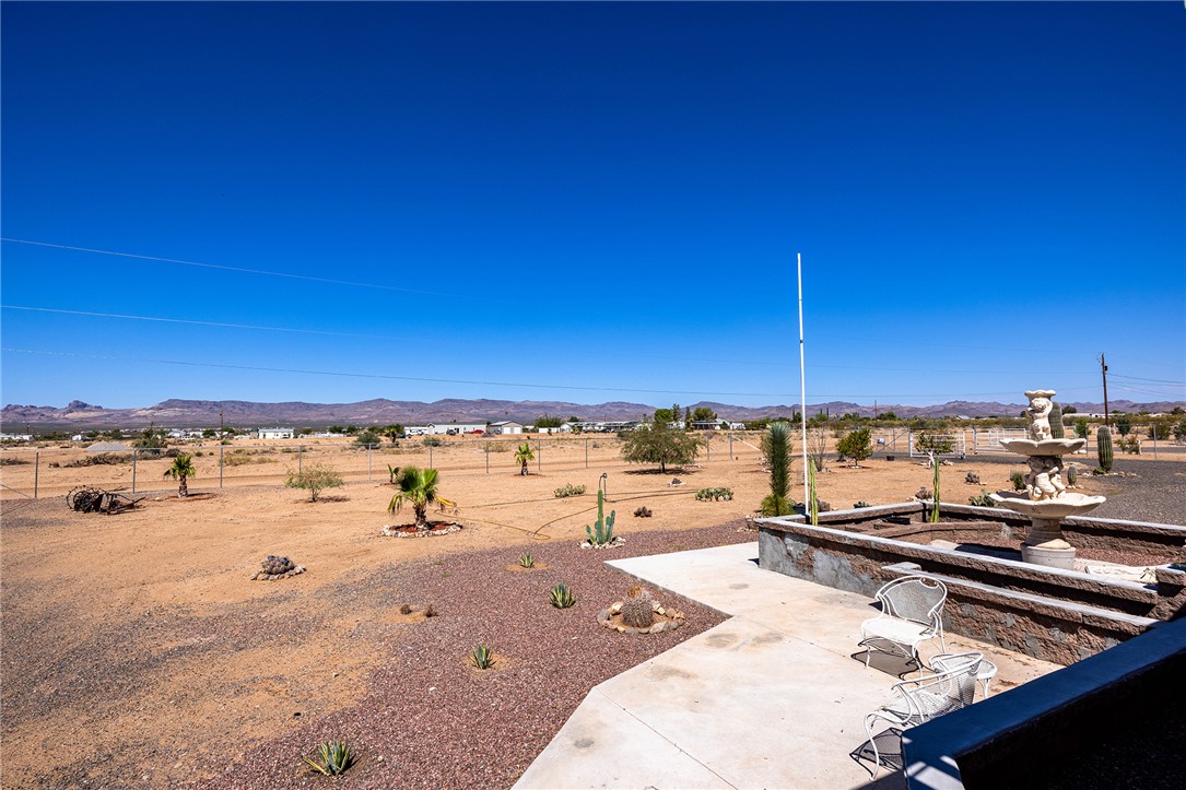 4206 Cordes Road Golden Valley, AZ 86413 - Photo 55 of 60 Spacious outdoor patio area with a tiered fountain, providing clear views of the surrounding desert landscape and distant mountains