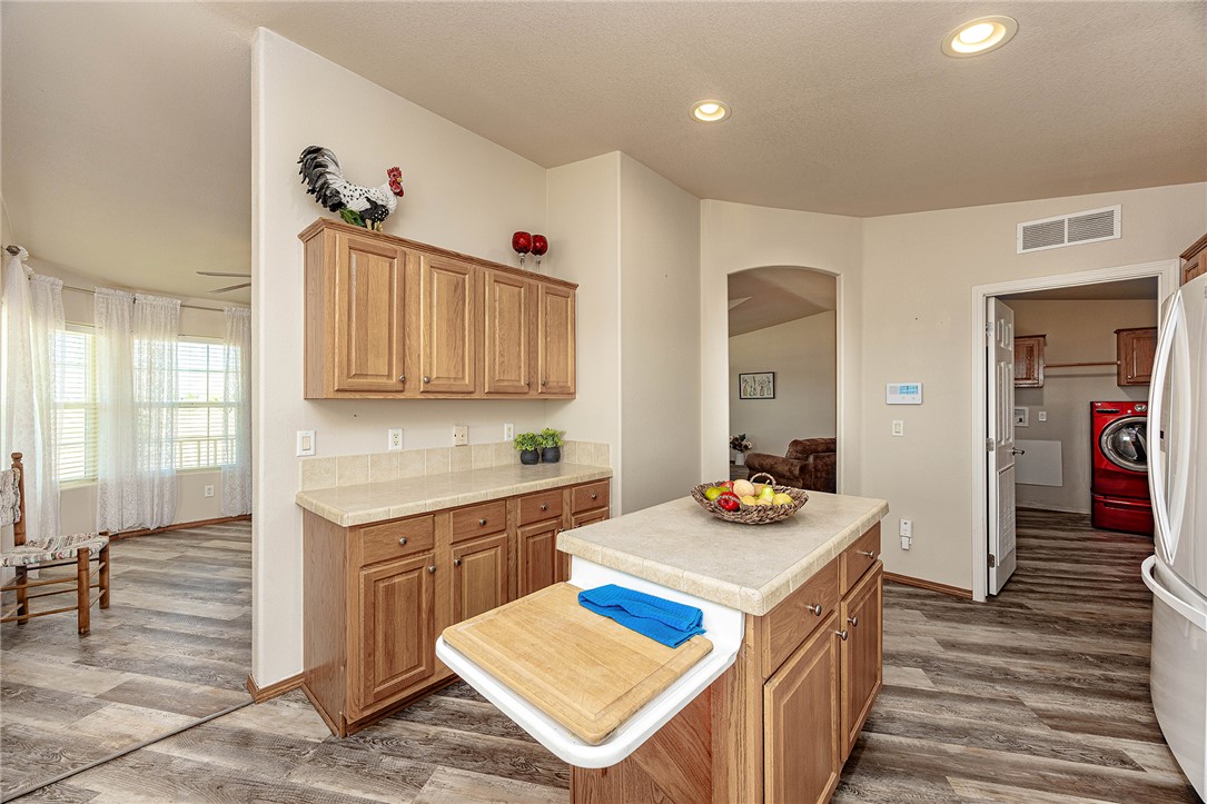 4206 Cordes Road Golden Valley, AZ 86413 - Photo 9 of 60 This kitchen features wood cabinetry, a central island with a countertop, and recessed lighting